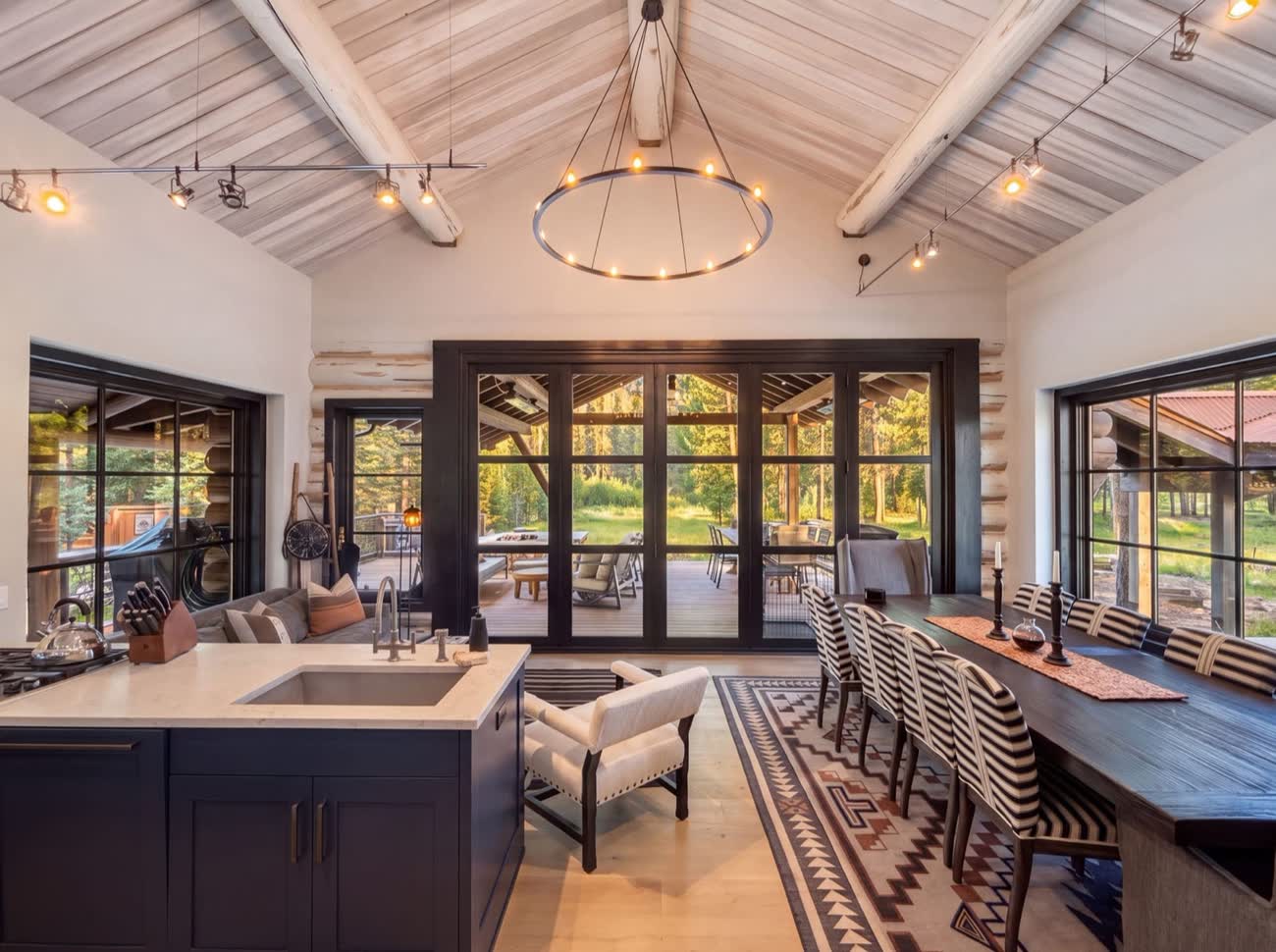 Vaulted great room of the Confluence Lodge with a long dining table